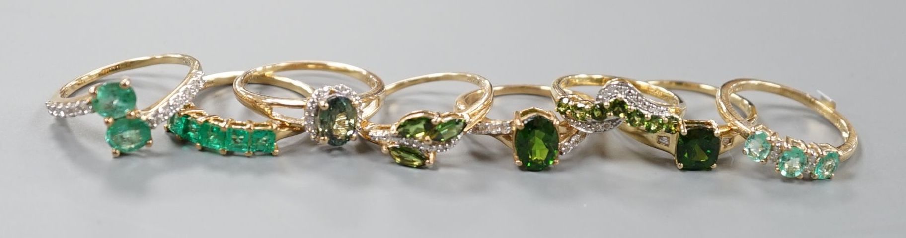 Eight assorted modern 9ct gold and gem set dress rings, including garnet, gross weight 16.8 grams.